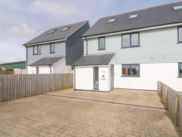 A pair of semi detached houses with driveways and wooden fences at Sea Dreams in Marazion