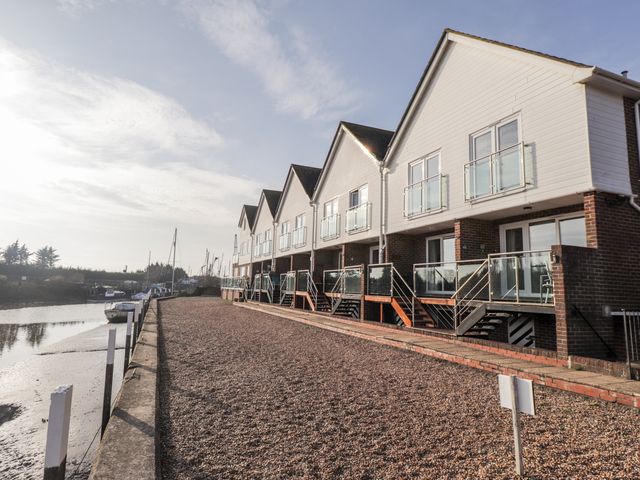 A row of houses with balconies along a waterfront at 3 Tidal in Rye