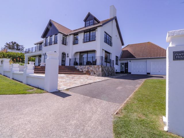 A two-story house with a tiled roof and a driveway at Pentire House in Kingsdown