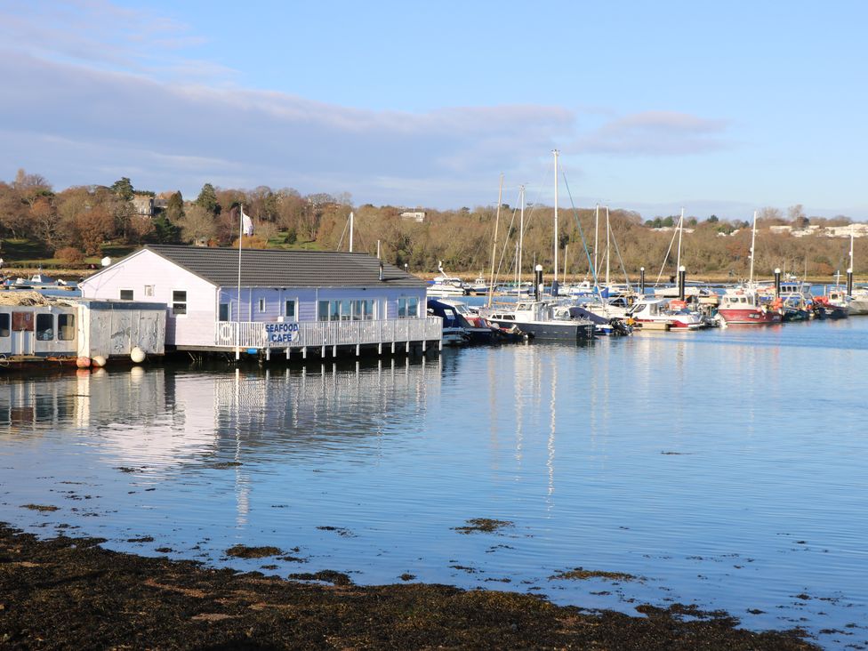 A waterfront seafood cafe with boats docked nearby and trees in the background at Chianti in Seaview