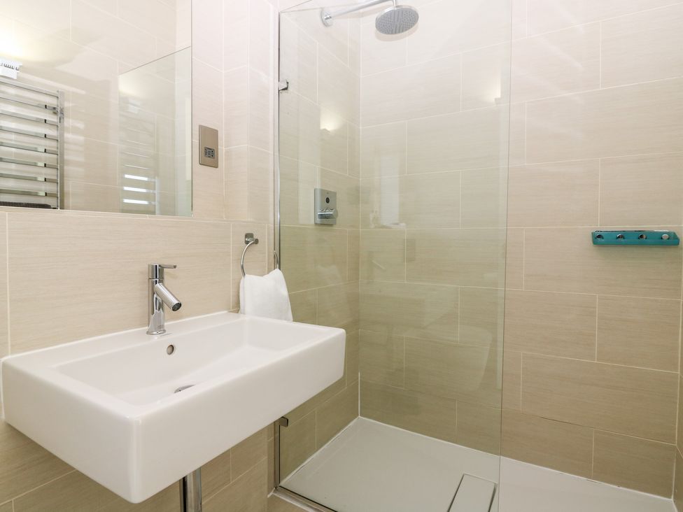 A bathroom with a wall-mounted sink and a walk-in shower at The Lodge in Dunecht near Westhill