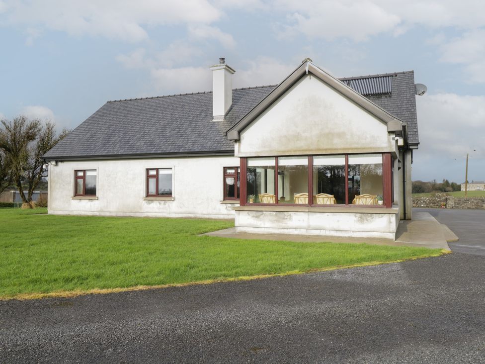 A house with a grass lawn and paved driveway at Bunny Lane in Cloonflynn near Ballycarra County Mayo