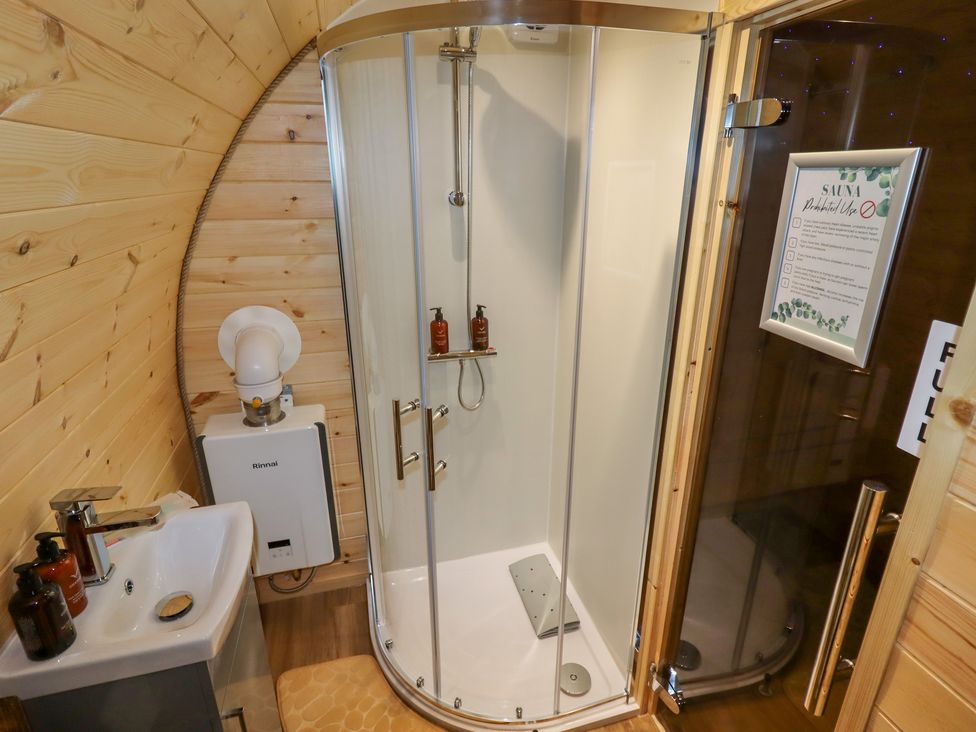 A bathroom with a corner shower, sink, and a sauna at Moel Famau Bryniau Clwyd near Denbigh