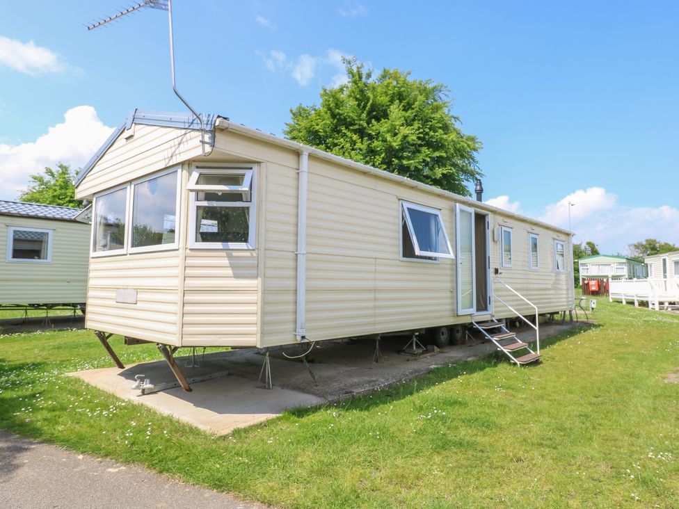 A mobile home on a concrete base with steps at the entrance at 626 in Burgh Castle