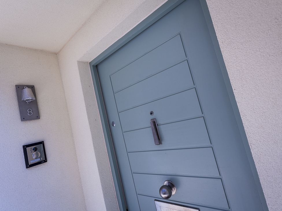A front door with a doorbell and bell with number 8 on a wall at Villa 8 Estura Salcombe